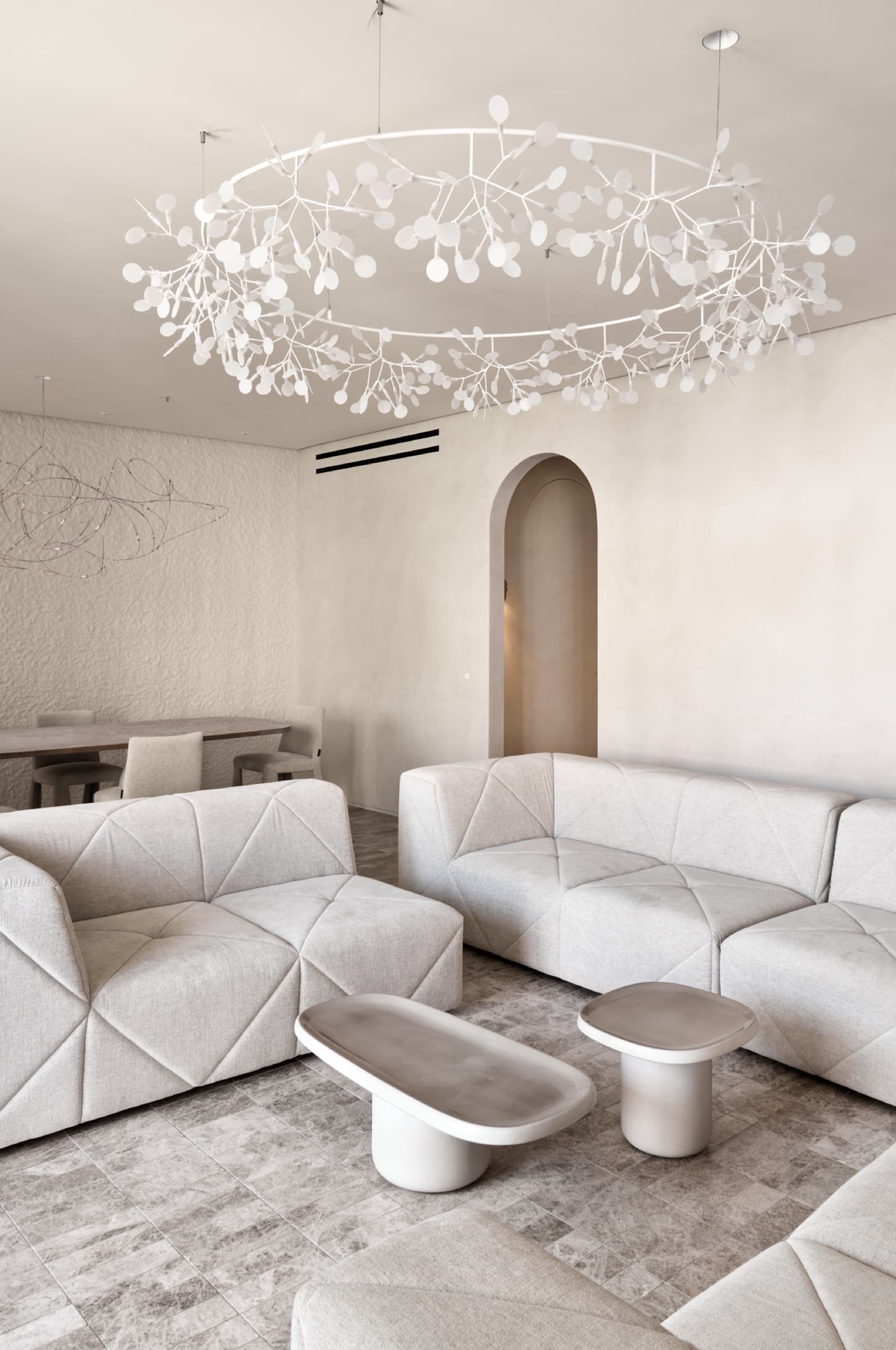 Living room with Heraflop chandelier and sculptural sofas